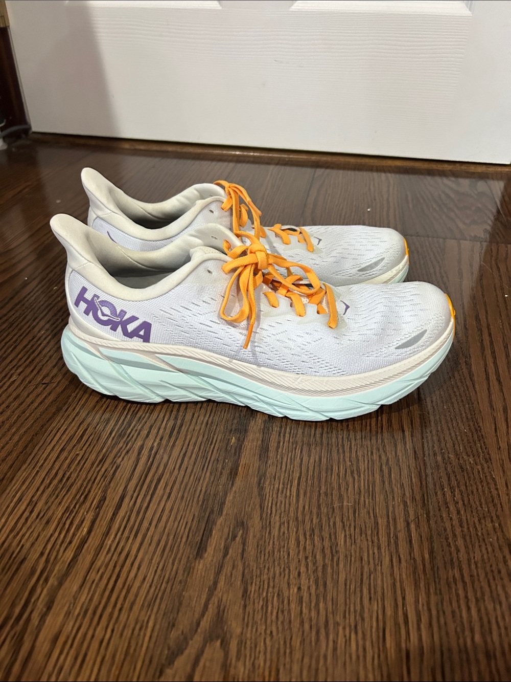 Hoka women’s Clifton White Sneakers with Orange Laces and Purple Logo Sz 10